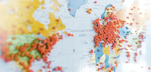 Huge number of red pins in Europe and other continents on a world map