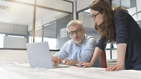 Industrial designers working together on project in office