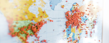 Huge number of red pins in Europe and other continents on a world map